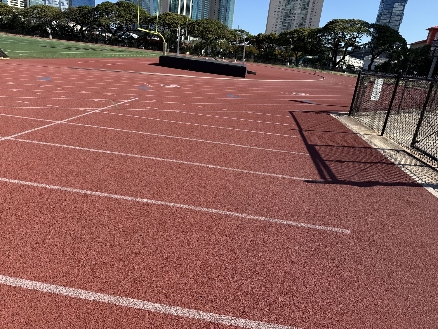 Empty red track with city skyline