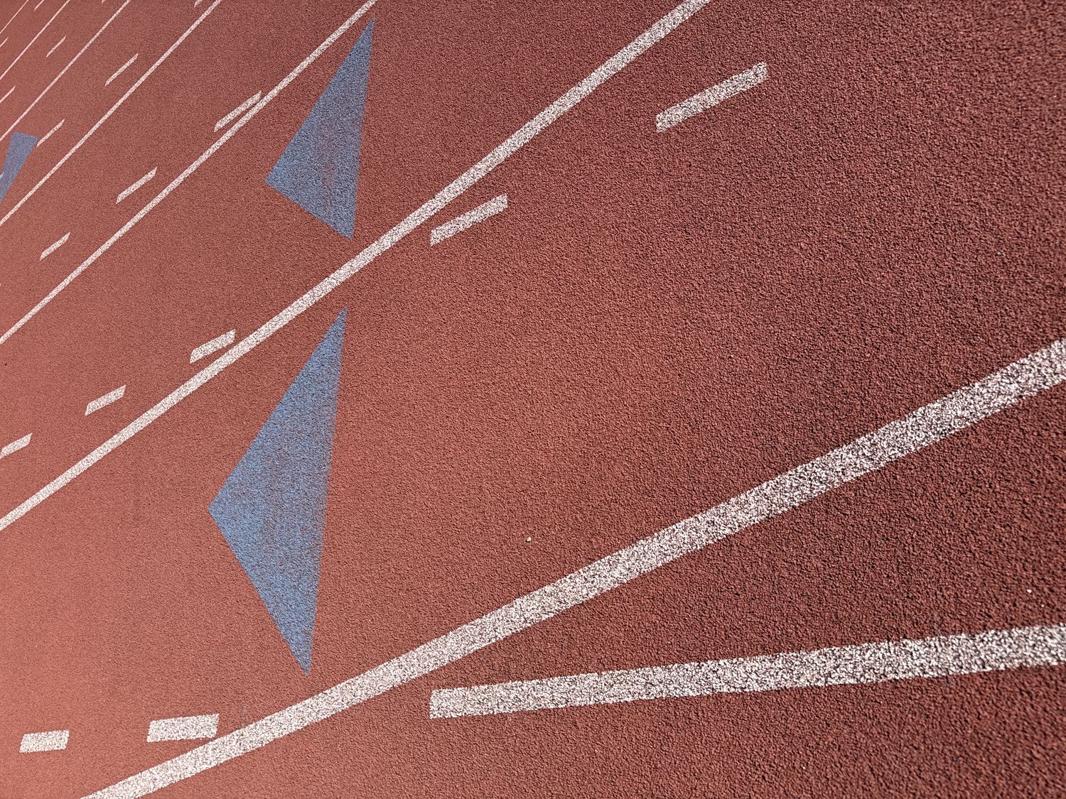 Close-up of blue stagger markers on red track