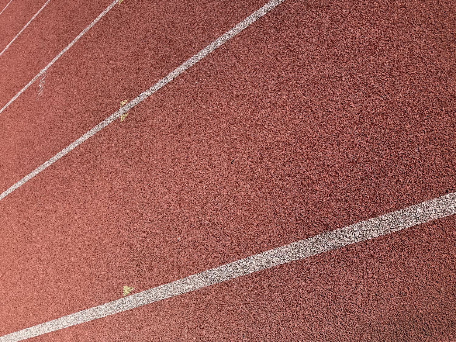 Red track surface with white lane markings