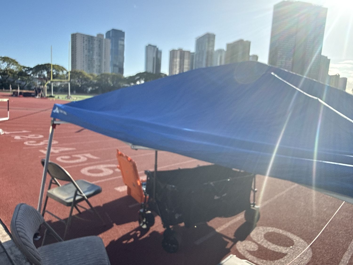 Canopy tent, folding chairs, and wagon set up trackside