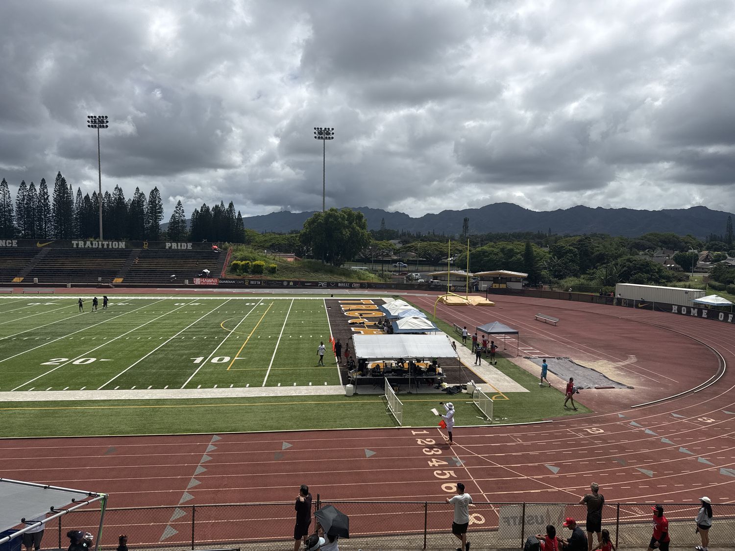 Track meet with tents and spectators at Mililani
