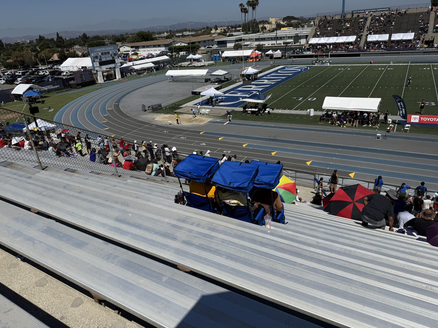 Stadium seats with sunshade canopies at a track meet
